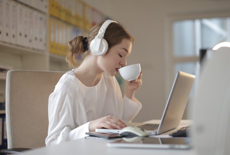 Woman working while listening to music for productivity