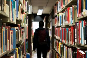 Person walking through a library corridor to show time blocking for students